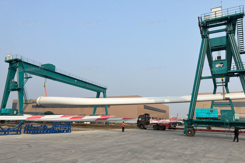 A-frame RTG crane lifting wind turbine components during on-site handling operations.